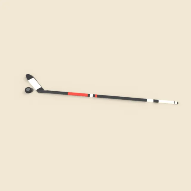 Ice hockey stick and puck