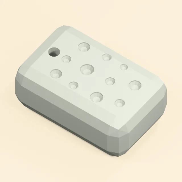 Rounded pumice grooming stone with recessed pores and hanging bore